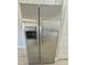 Stainless steel refrigerator with water dispenser in updated kitchen with white cabinets at 2336 Nansen Ave, Orlando, FL 32817