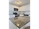Bright kitchen featuring granite countertops, stainless steel appliances and white cabinetry at 2336 Nansen Ave, Orlando, FL 32817