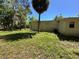 Side view of house and backyard with palm tree at 24047 Ermine Rd, Astor, FL 32102