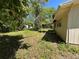 Backyard view of the home and covered patio at 24047 Ermine Rd, Astor, FL 32102