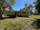Back view of the single story home with siding at 24047 Ermine Rd, Astor, FL 32102