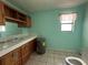 Bathroom with a toilet, sink with countertop, and hot water heater at 24047 Ermine Rd, Astor, FL 32102