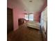 Bedroom with natural light, plywood flooring, piano and closet at 24047 Ermine Rd, Astor, FL 32102