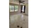 Bedroom featuring a ceiling fan, two windows providing natural light, and outdated flooring at 24047 Ermine Rd, Astor, FL 32102