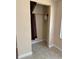 Small closet with a rod for hanging clothes, and dated flooring and walls at 24047 Ermine Rd, Astor, FL 32102