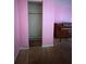 Bedroom closet with plywood flooring and a single hanging rod at 24047 Ermine Rd, Astor, FL 32102