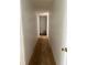 Narrow hallway with damaged flooring and outdated decor at 24047 Ermine Rd, Astor, FL 32102