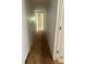 Hallway with plywood flooring and peeling paint at 24047 Ermine Rd, Astor, FL 32102
