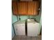 Laundry room with a washer, dryer, and upper cabinets at 24047 Ermine Rd, Astor, FL 32102