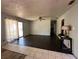 View of the living room with wood floors, sliding glass doors and overhead fan at 24047 Ermine Rd, Astor, FL 32102