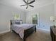 Cozy bedroom with neutral decor, comfortable carpeting, and soft, natural light at 302 W Park St, Lakeland, FL 33803