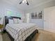 Comfortable bedroom with a cozy bed, ceiling fan, and natural light at 302 W Park St, Lakeland, FL 33803