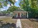 Charming single-story home with a welcoming front porch and red front door at 302 W Park St, Lakeland, FL 33803