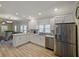 Well-lit kitchen with stainless steel appliances, granite countertops, white cabinetry, and an open floor plan at 302 W Park St, Lakeland, FL 33803