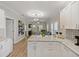 Modern kitchen with white cabinets, stainless steel appliances and granite countertops with an open floor plan at 302 W Park St, Lakeland, FL 33803