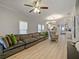 Spacious living room features hardwood floors, recessed lighting and open concept design to kitchen at 302 W Park St, Lakeland, FL 33803
