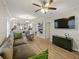 Open-concept living room with hardwood floors, recessed lighting, and seamlessly connected kitchen area at 302 W Park St, Lakeland, FL 33803
