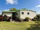 Side yard showing well-maintained lawn and mature landscaping around the home at 334 Palo Verde Dr, Leesburg, FL 34748