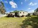 Backyard view featuring lush lawn and mature landscaping at 334 Palo Verde Dr, Leesburg, FL 34748