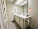 Clean bathroom boasts a vanity with sink and storage, complemented by a tiled backsplash at 334 Palo Verde Dr, Leesburg, FL 34748