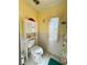 Cozy bathroom with a toilet and cabinet for storage and a window at 334 Palo Verde Dr, Leesburg, FL 34748