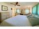 Cozy bedroom featuring a bed with decorative pillows, wicker dresser, and a serene ambiance at 334 Palo Verde Dr, Leesburg, FL 34748