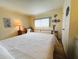 Inviting bedroom with a queen bed, a desk with lamp, and decorative wall art at 334 Palo Verde Dr, Leesburg, FL 34748