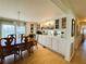 Well lit dining area with custom cabinetry leading into the living room with beautiful decorations at 334 Palo Verde Dr, Leesburg, FL 34748
