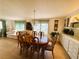 Well lit dining area leading into the living room with beautiful decorations at 334 Palo Verde Dr, Leesburg, FL 34748