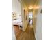 Hallway leads to a bedroom and kitchen, enhanced with wood floors and decor at 334 Palo Verde Dr, Leesburg, FL 34748