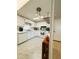 Bright kitchen with white cabinetry and stainless appliances, door leading to outside at 334 Palo Verde Dr, Leesburg, FL 34748
