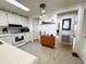 Bright kitchen with white cabinetry and stainless appliances, open floor plan at 334 Palo Verde Dr, Leesburg, FL 34748
