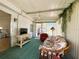 Well-lit lanai with comfortable seating, a television, and bright natural light at 334 Palo Verde Dr, Leesburg, FL 34748