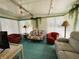 Inviting lanai featuring comfortable seating, large windows, and a ceiling fan at 334 Palo Verde Dr, Leesburg, FL 34748