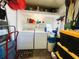 Functional laundry room with washer, dryer, and ample storage shelving at 334 Palo Verde Dr, Leesburg, FL 34748