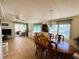 Spacious living room with wood flooring and a beautiful dining set, great lighting at 334 Palo Verde Dr, Leesburg, FL 34748