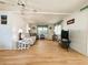 Open-concept living room with wood floors and lots of seating with a nice view to the outdoors at 334 Palo Verde Dr, Leesburg, FL 34748