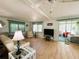 Bright living room featuring wood floors, stylish furnishings, and plenty of natural light at 334 Palo Verde Dr, Leesburg, FL 34748