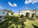 Well-maintained side yard with manicured landscaping and lush green grass at 334 Palo Verde Dr, Leesburg, FL 34748