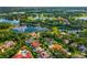 Aerial view of a community of homes surrounded by lakes and lush green trees at 365 N Spaulding Cv, Lake Mary, FL 32746