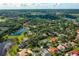 Stunning aerial view of a residential community featuring lush landscaping and a picturesque lake at 365 N Spaulding Cv, Lake Mary, FL 32746