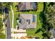 Aerial view of home with pool and solar panels, beautifully landscaped yard, and driveway at 365 N Spaulding Cv, Lake Mary, FL 32746