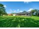 Spacious backyard with lush green grass, screened pool and mature trees at 365 N Spaulding Cv, Lake Mary, FL 32746