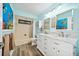 Charming bathroom featuring a double vanity, bathtub with shower, and stylish decor with marine-themed accents at 365 N Spaulding Cv, Lake Mary, FL 32746
