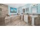 Elegant bathroom boasts marble countertops, dual sinks, separate shower, and soaking tub at 365 N Spaulding Cv, Lake Mary, FL 32746