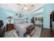 Light-filled bedroom boasts tray ceilings, an area rug, and access to the outdoor area at 365 N Spaulding Cv, Lake Mary, FL 32746