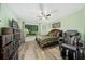 Cozy bedroom with a comfortable bed, ceiling fan, window seat, and a relaxing massage chair at 365 N Spaulding Cv, Lake Mary, FL 32746
