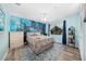 Vibrant bedroom with an ocean-themed mural, comfortable bed, and ample natural light from a large window at 365 N Spaulding Cv, Lake Mary, FL 32746