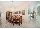 Formal dining room with a chandelier, seating for ten, and a view of the lanai at 365 N Spaulding Cv, Lake Mary, FL 32746