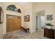 The foyer features double wood doors, a decorative chandelier, a mirror, and tile flooring at 365 N Spaulding Cv, Lake Mary, FL 32746